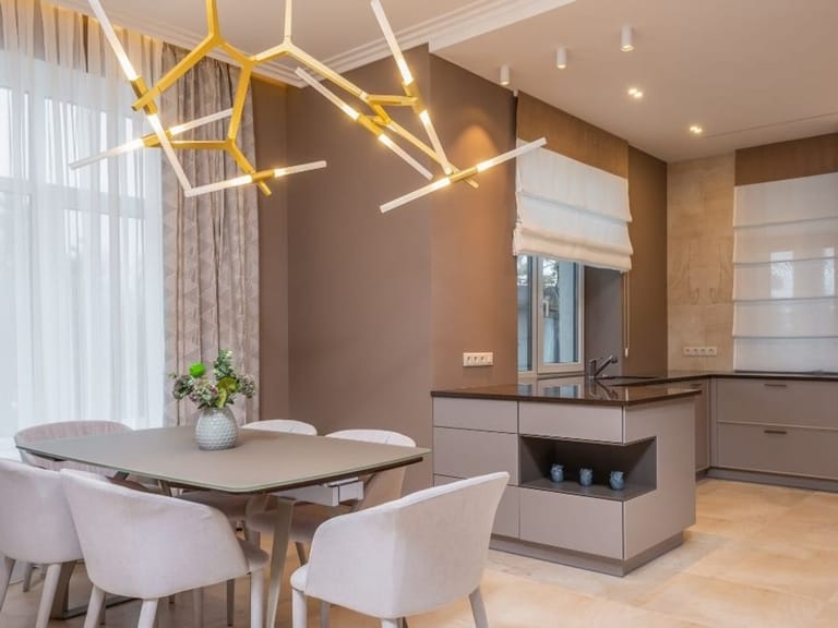 Open kitchen and dining area with an island and pendant lights