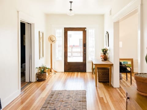 Bright entryway with a front door and a hardwood floor