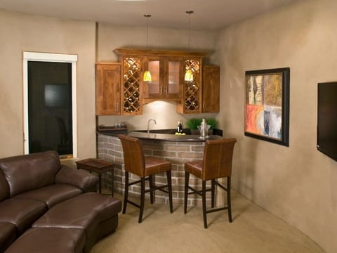 Living room with a leather sofa and a wooden bar
