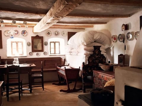 Rustic dining room with wooden beams and plates on the wall
