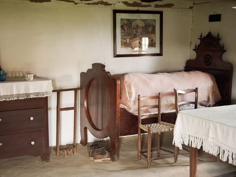 Rustic bedroom with a bed, a dresser and a mirror