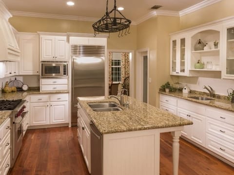 Large kitchen with a center island and white cabinets