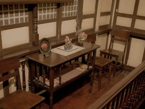 Wooden table and chairs on an upstairs landing