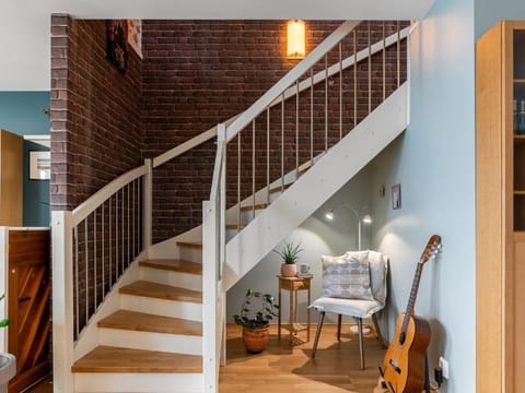 Interior staircase next to an exposed brick wall