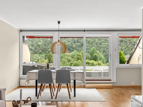 Dining area with a table, chairs and large windows