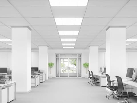 Large open office with rows of desks and chairs